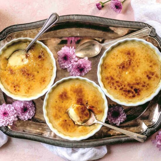 Vegan creme brulee serve in ramekins with spoons.