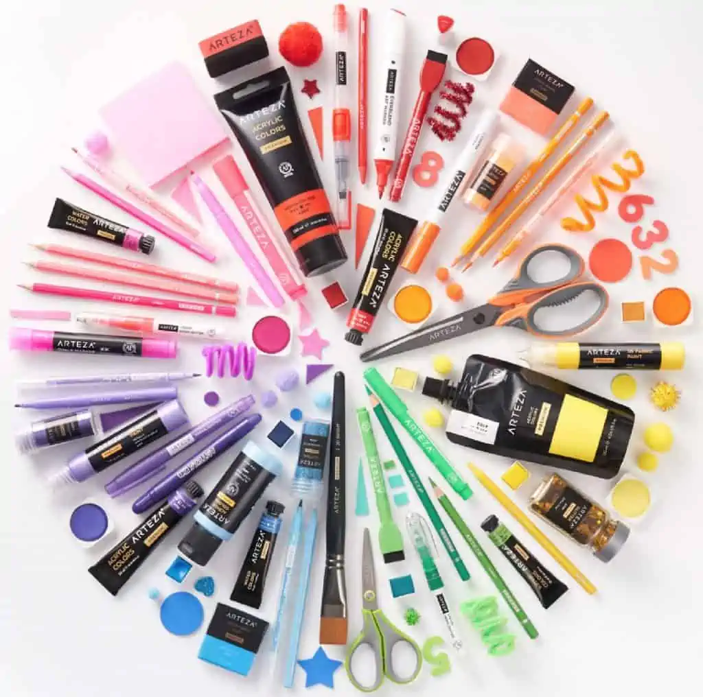 A set of rainbow colored Arteza art supplies arranged in a circle on a white background.