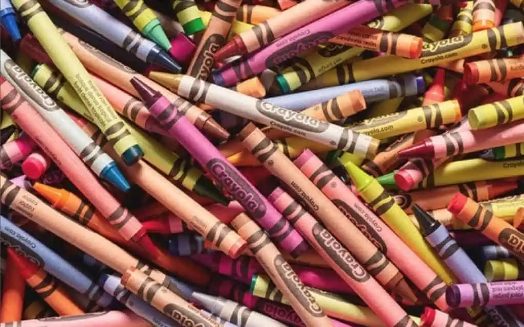 Colorful Crayola crayons arranged in a messy pile.