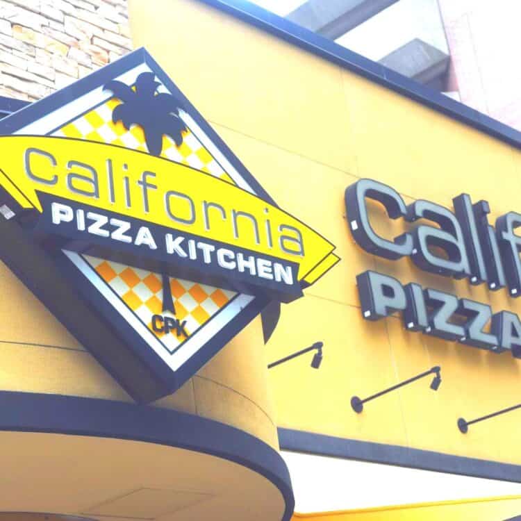 California Pizza Kitchen building with vegan CPK menu sign.