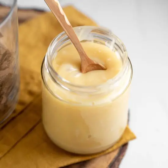 jar or vegan condensed milk made from coconut with a spoon