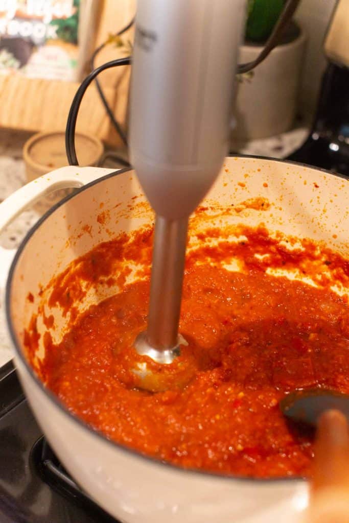 blending arrabiata sauce with an immersion blender