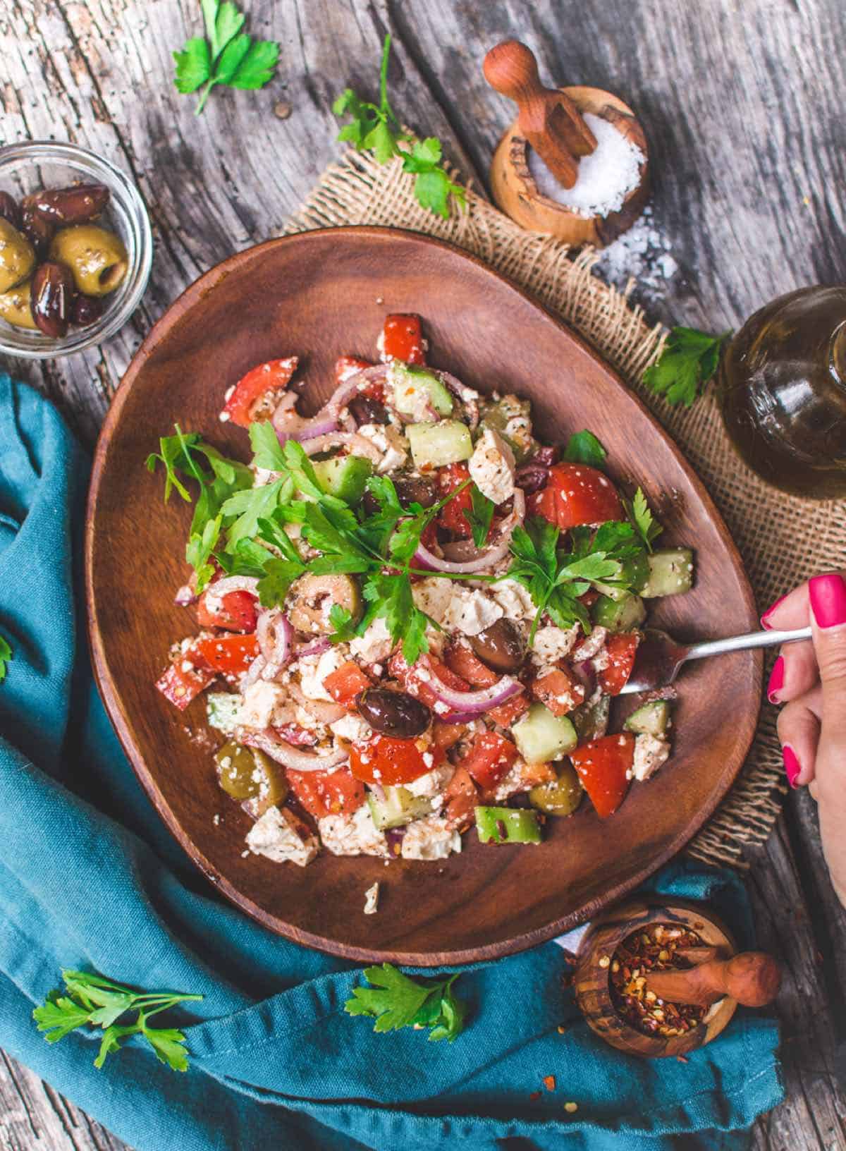 vegan greek salad with tomatoes onion olives and feta tofu