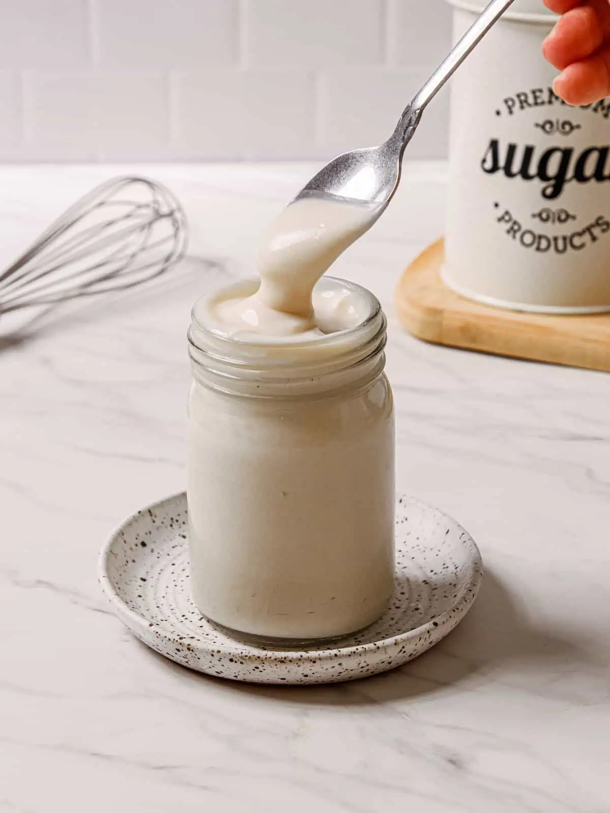 Finished recipe for vegan condensed milk in a jar. 