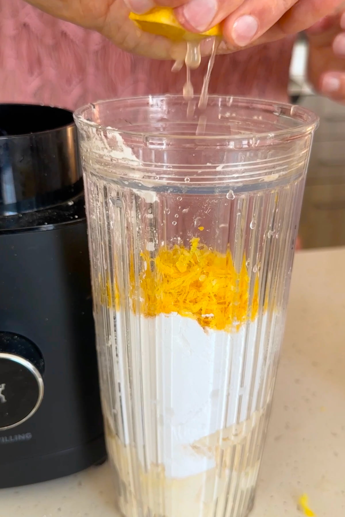 Silken tofu, powdered sugar, lemon zest and lemon juice added to a small personal blender cup.
