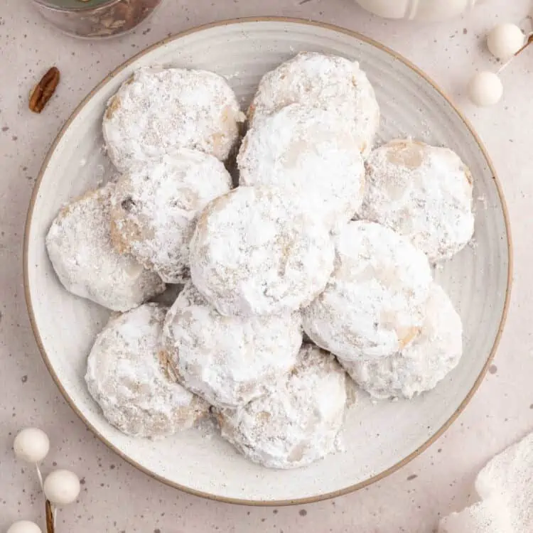 Vegan Mexican Wedding cookies stacked on a plate.