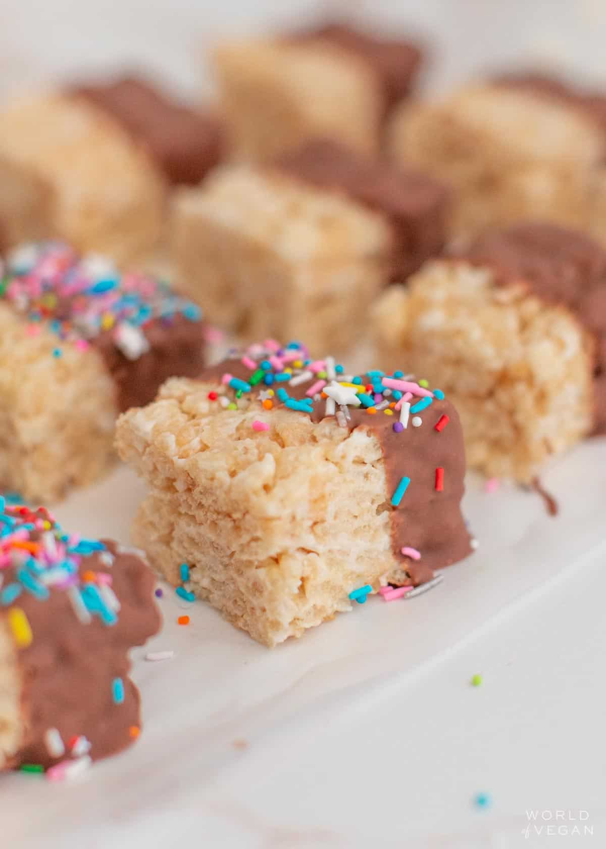 close up of dairy free rice krispies treats dipped in chocolate with sprinkles