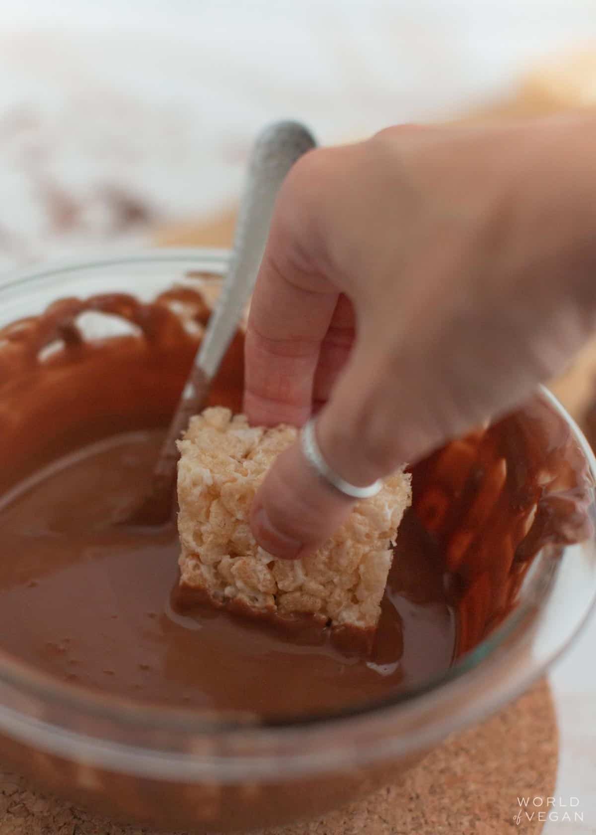 dip rice krispies treats into melted chocolate