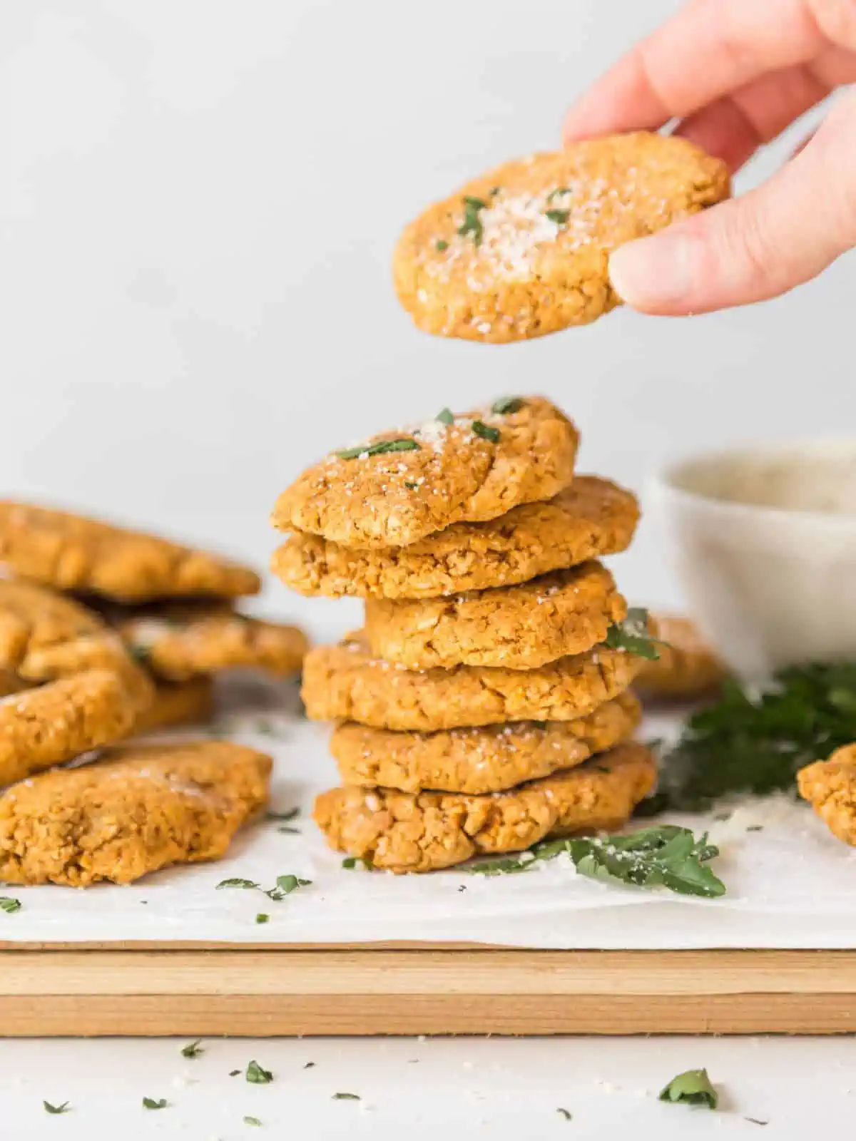 A stack of veggie nuggets with hand picking up a nugget.