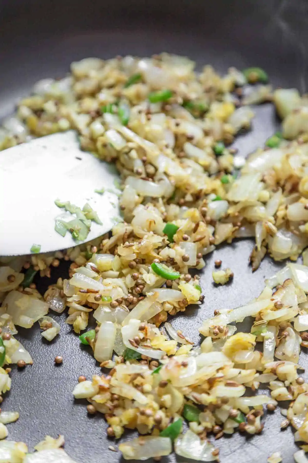 Onions and seasonings cooking in a large skillet.