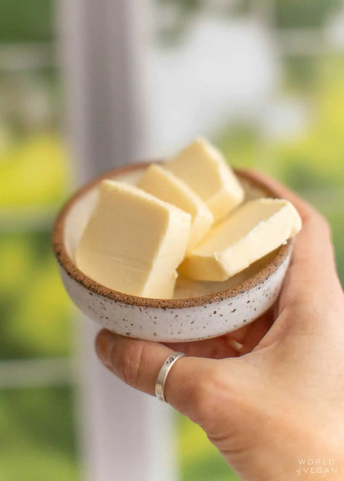 sliced dairy-free butter in a rustic ceramic dish