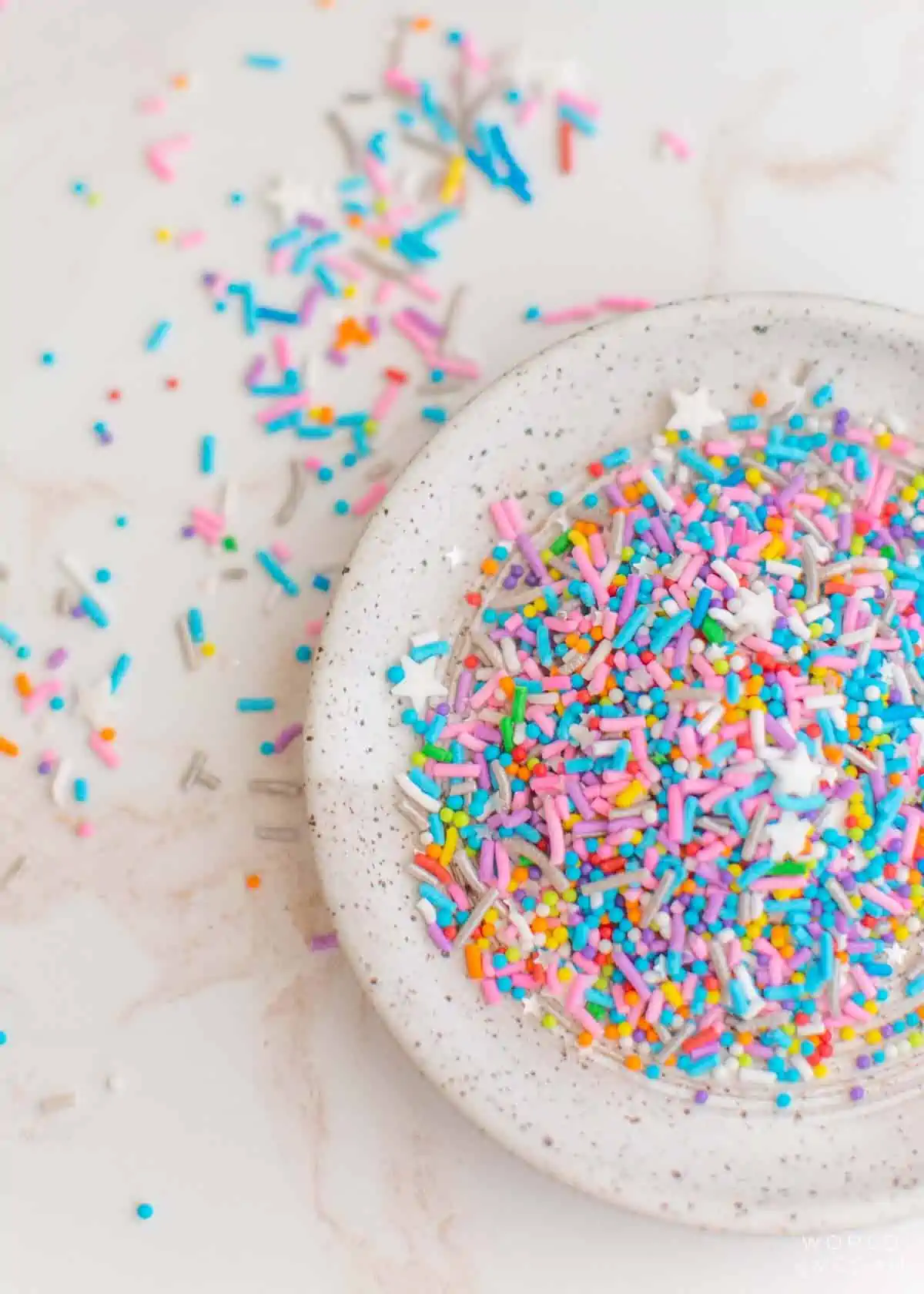 Vegan rainbow sprinkles on a small dish.