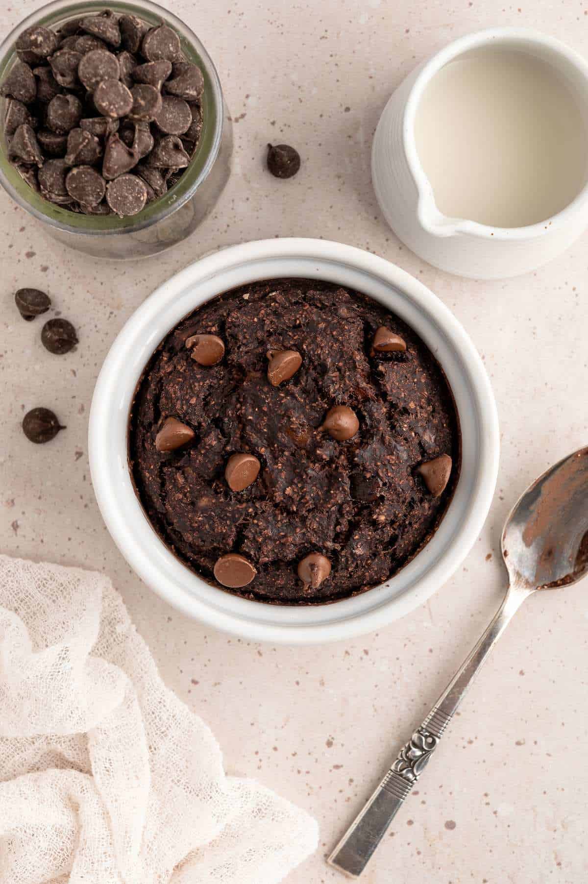 Chocolate baked oats protein mug cake in a ramekin.