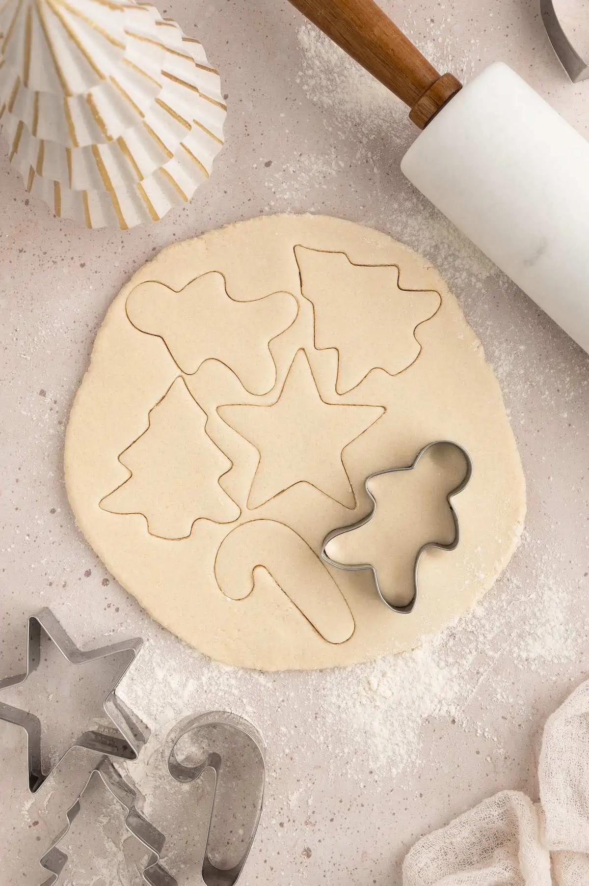 Salt dough rolled flat with cookie cutter placed on top.