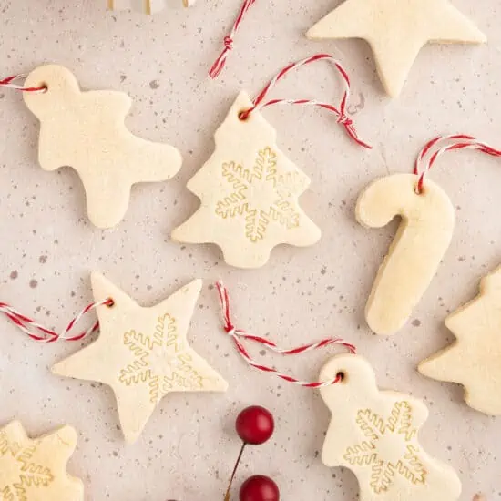 Salt dough ornaments shaped like Christmas trees, candy canes, gingerbread men, and stars.