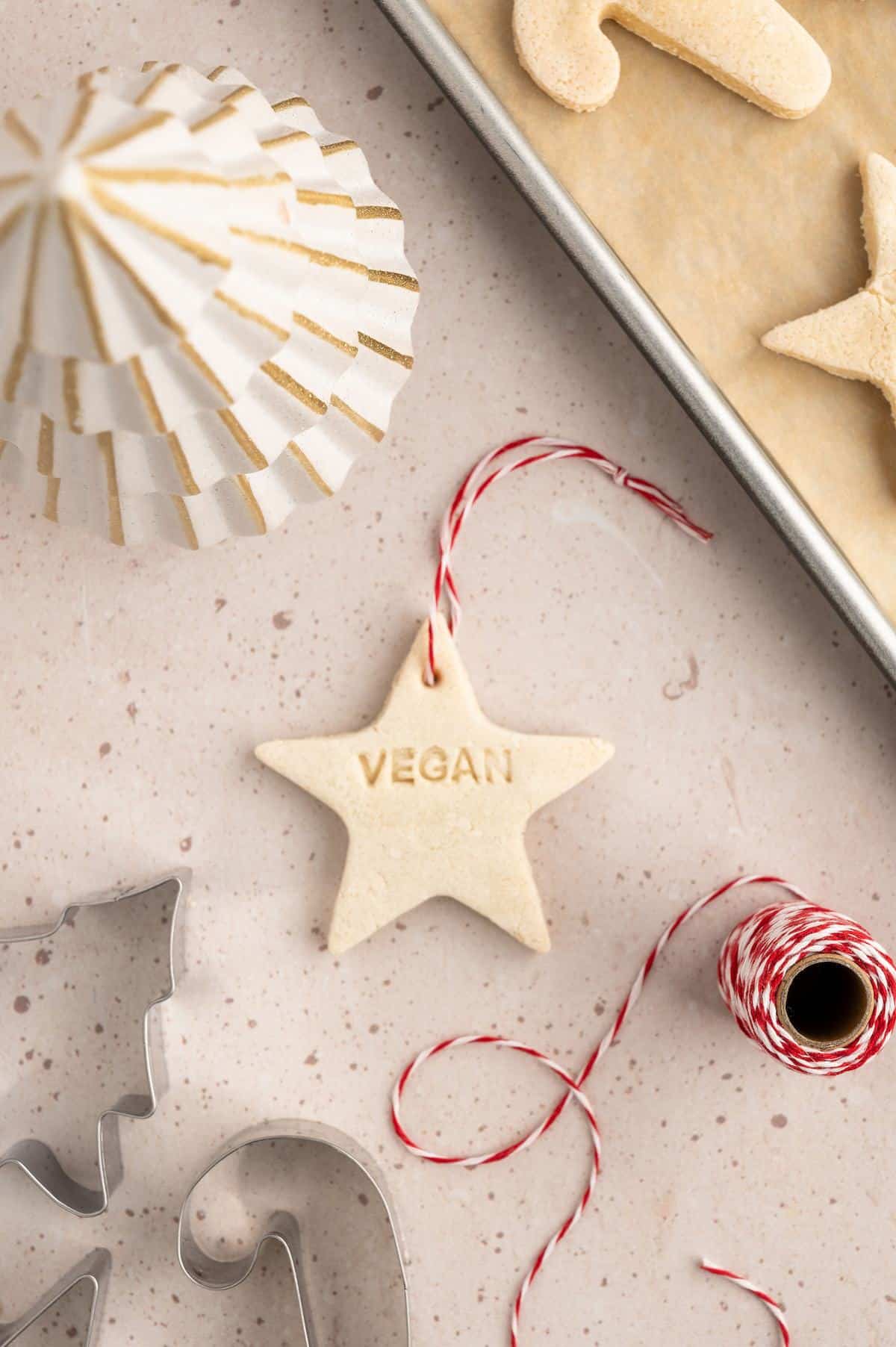 Salt dough ornament with the word "vegan" stamped on it.