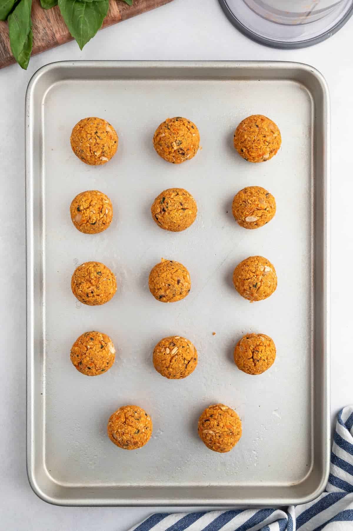 Veggie meatballs on a baking sheet.