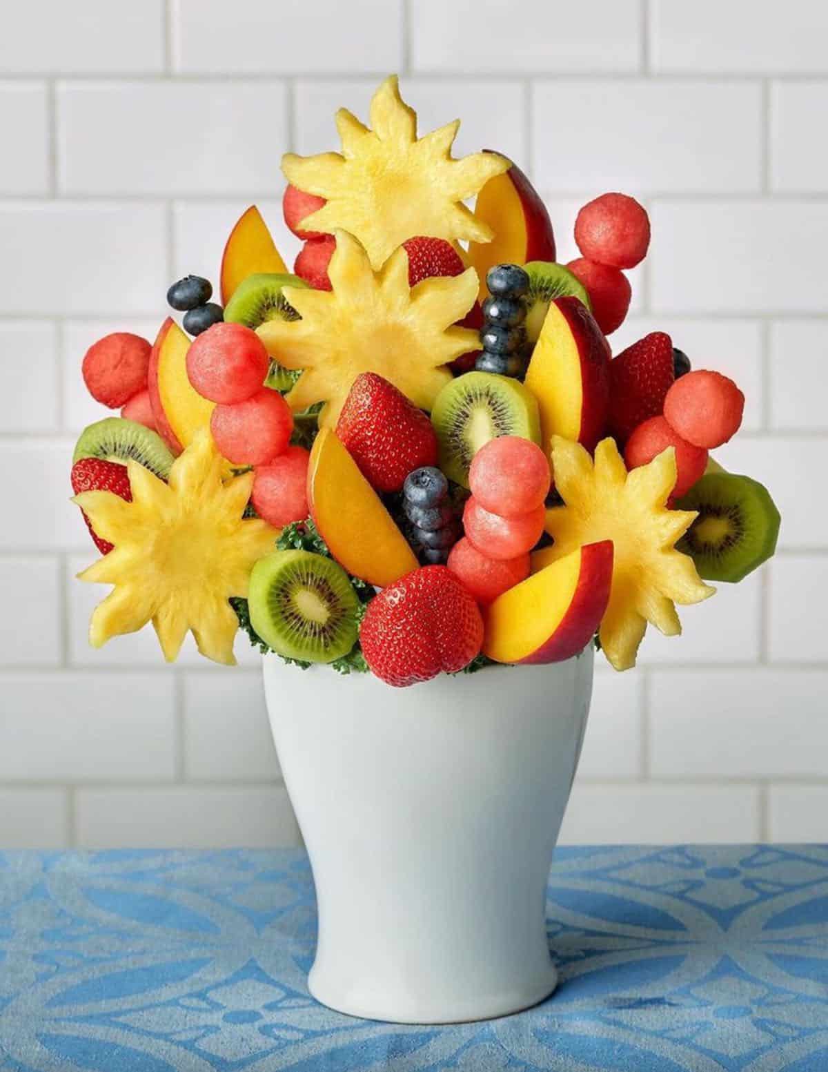 White vase with beautiful fresh fruit bouquet from Edible arrangements.