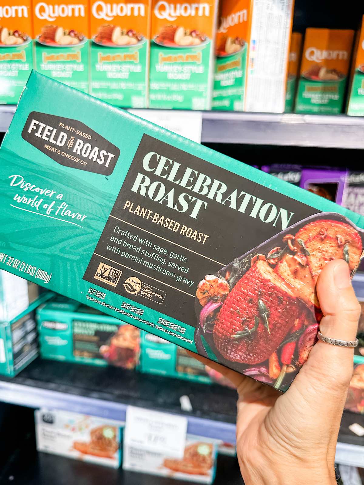 A box of Field Roast's Celebration Roast at Whole Foods Market in front of a shelf of vegan turkey options. 