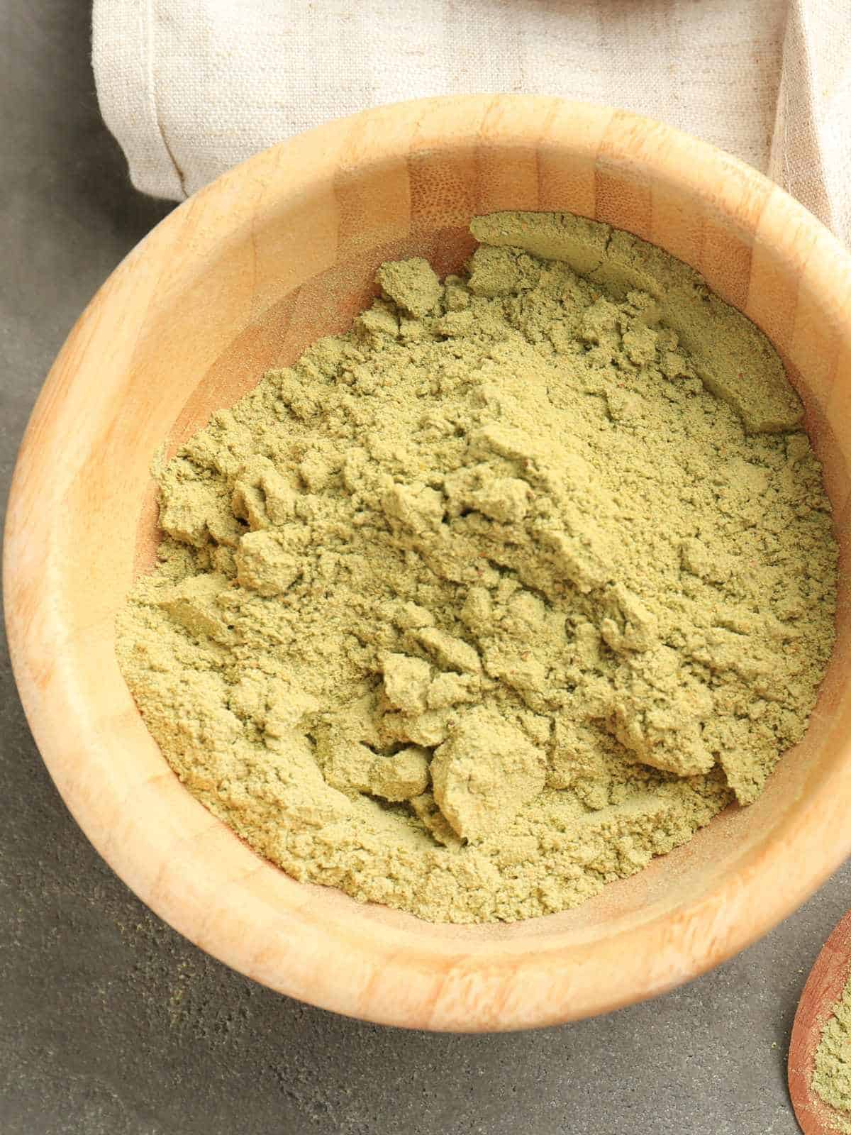 Hemp protein powder in a wooden bowl.