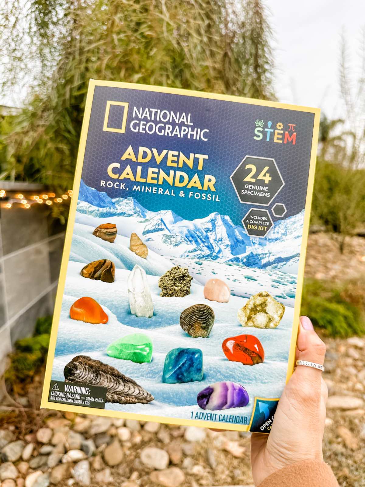 Holding out the National Geographic advent calendar with gemstones. 