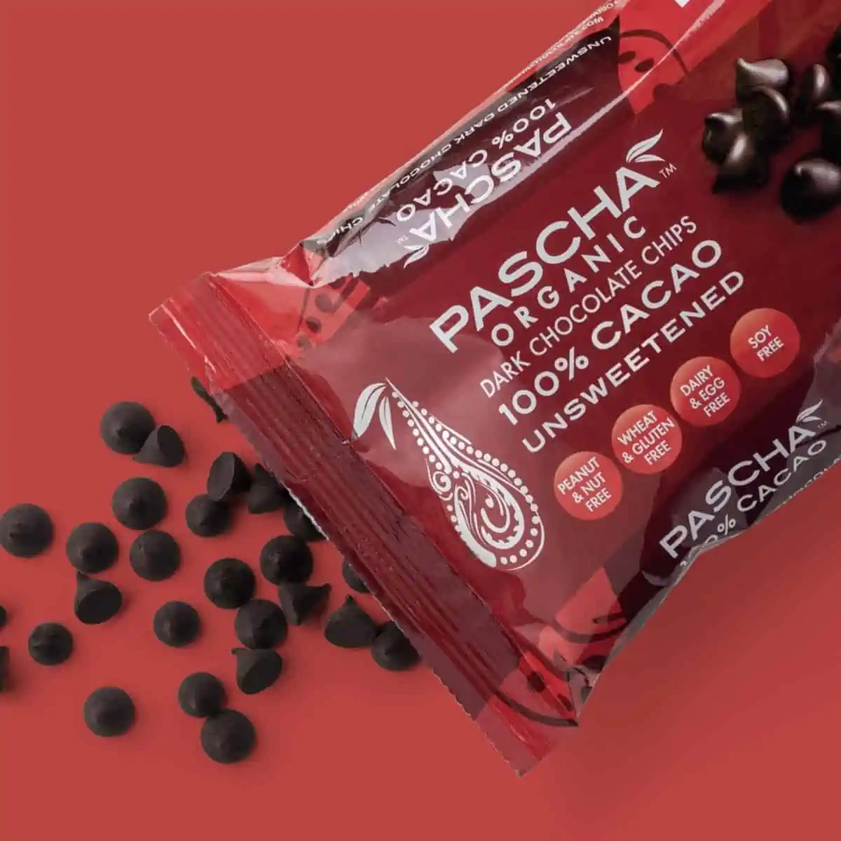 Pascha brand cacao dark chocolate chips for baking spilling out of a bag.