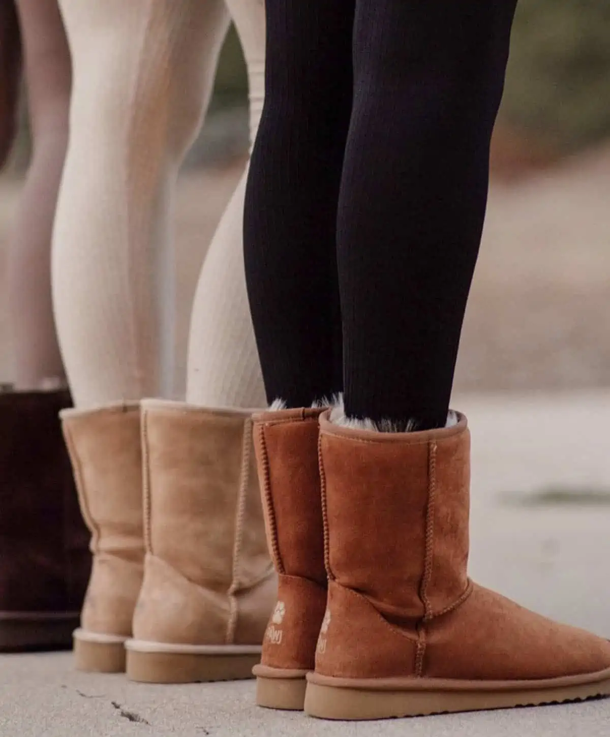 three woman wearing Pawj vegan ugg boots in colors tan and dark brown