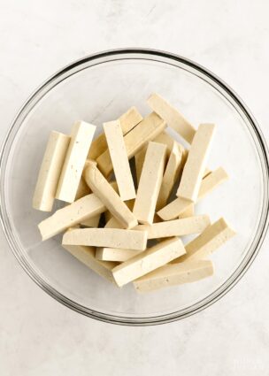 Plain tofu fries in a glass mixing bowl.