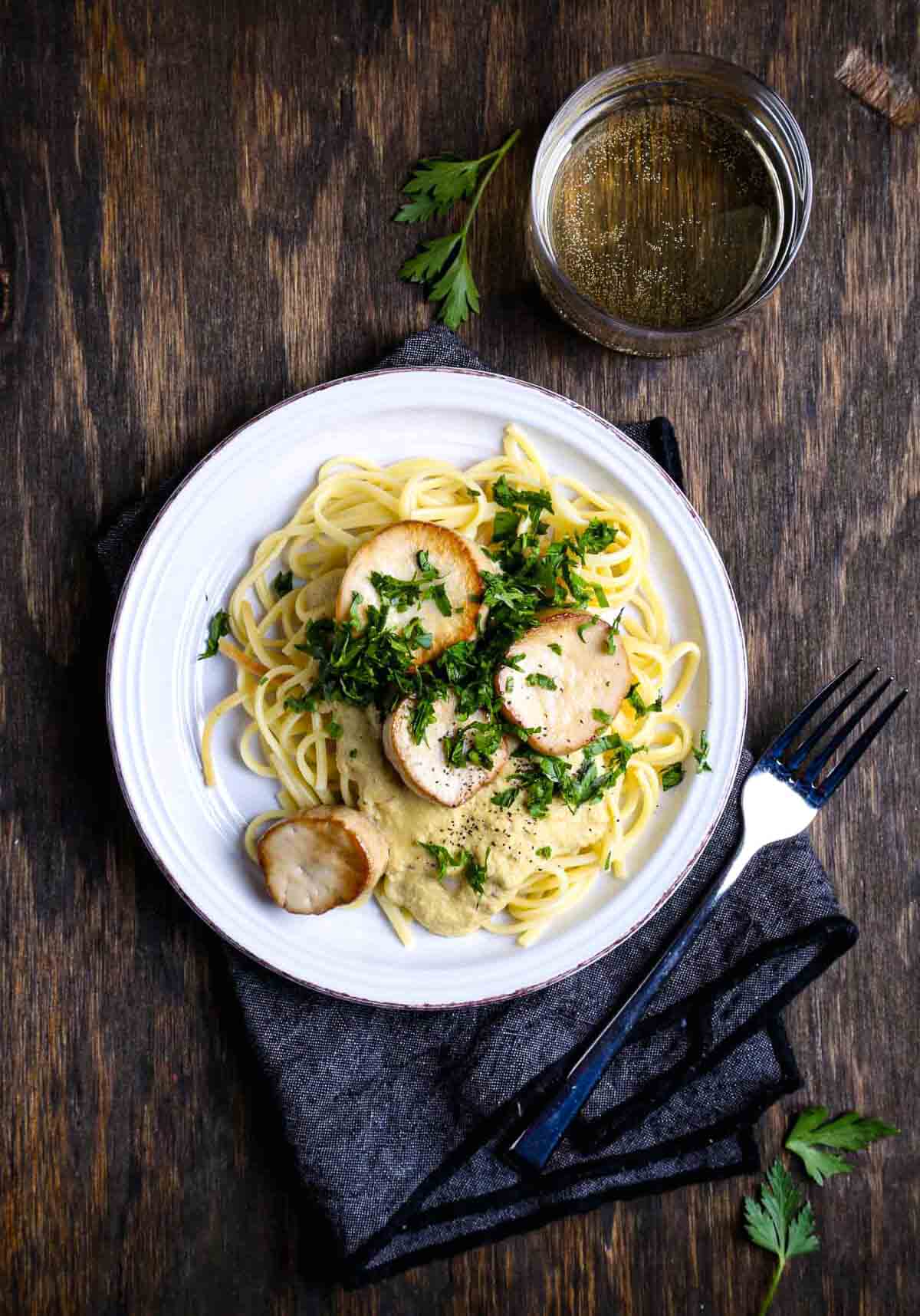 Creamy vegan mushroom pasta with seared king oyster mushrooms and fresh parsley.
