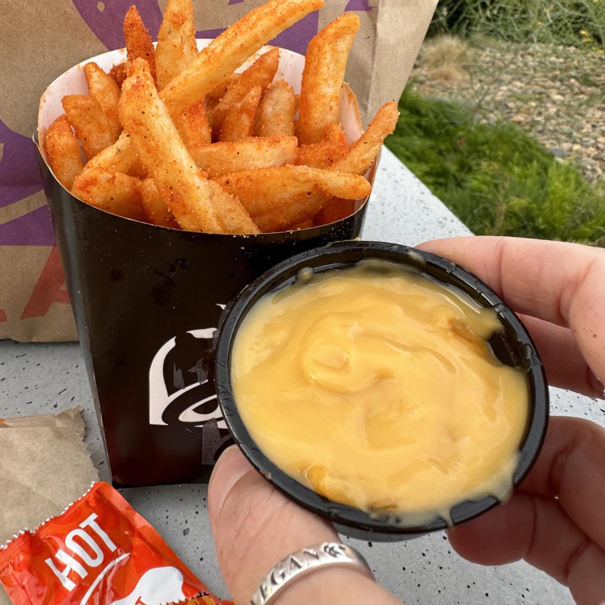 A spread of vegan taco bell menu options including the vegan nacho cheese fries.