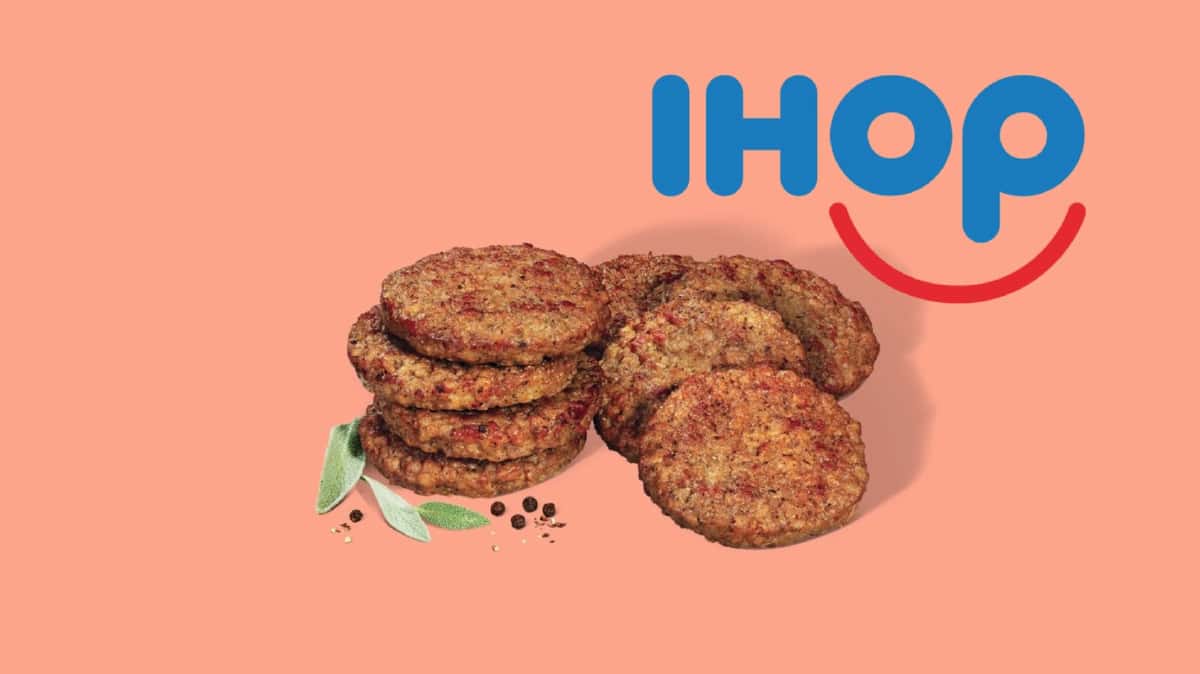 Eight Impossible Sausage patties stacked against a pink background and the blue IHOP symbol above.