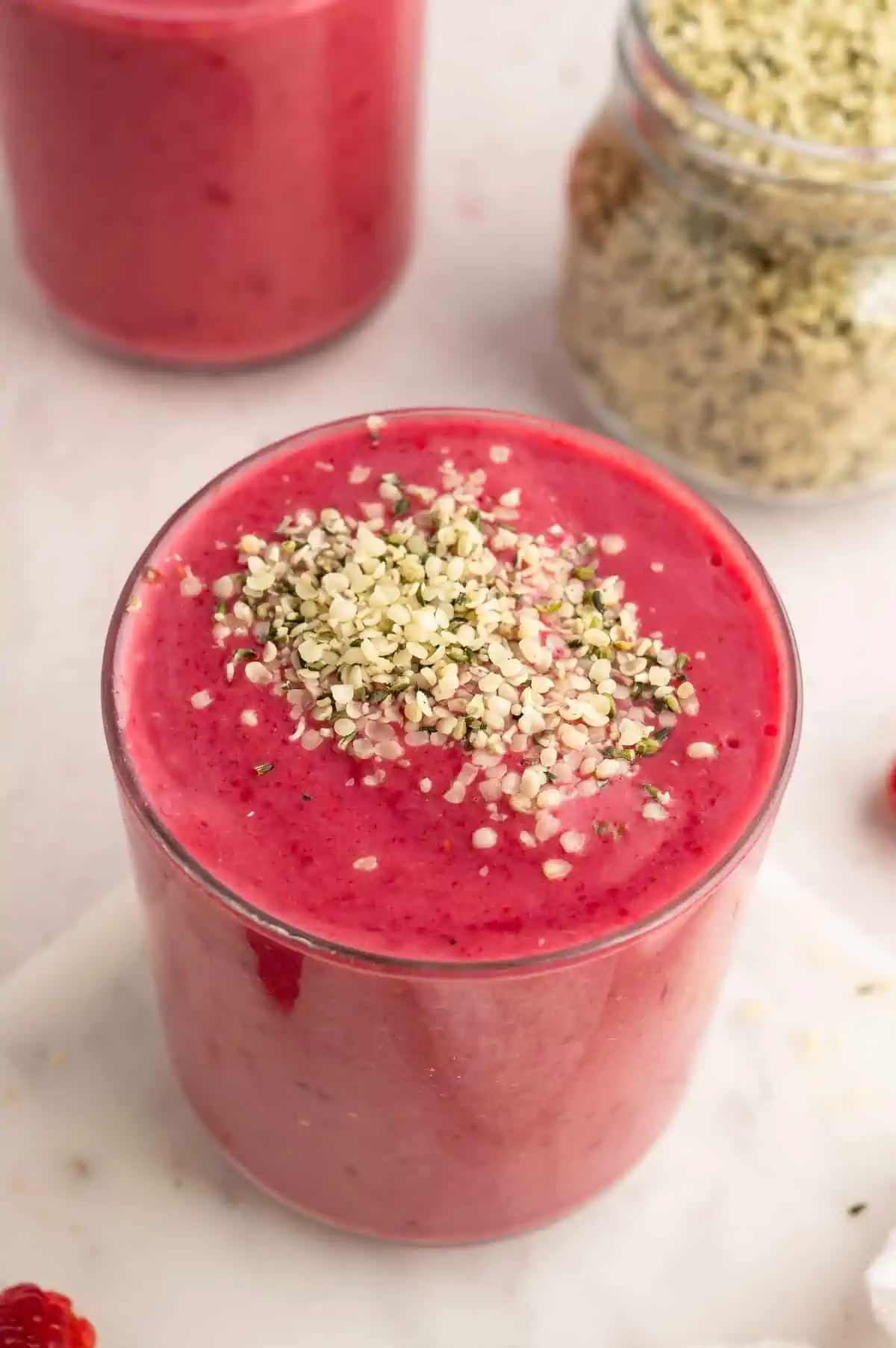 A raspberry smoothie topped with hemp seeds.
