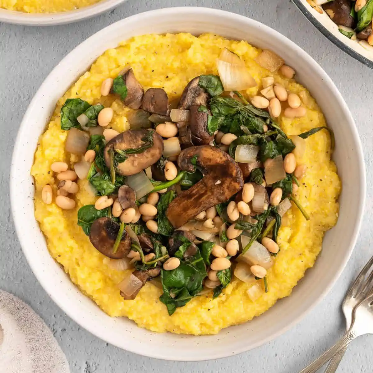 A bowl of vegan polenta and greens.