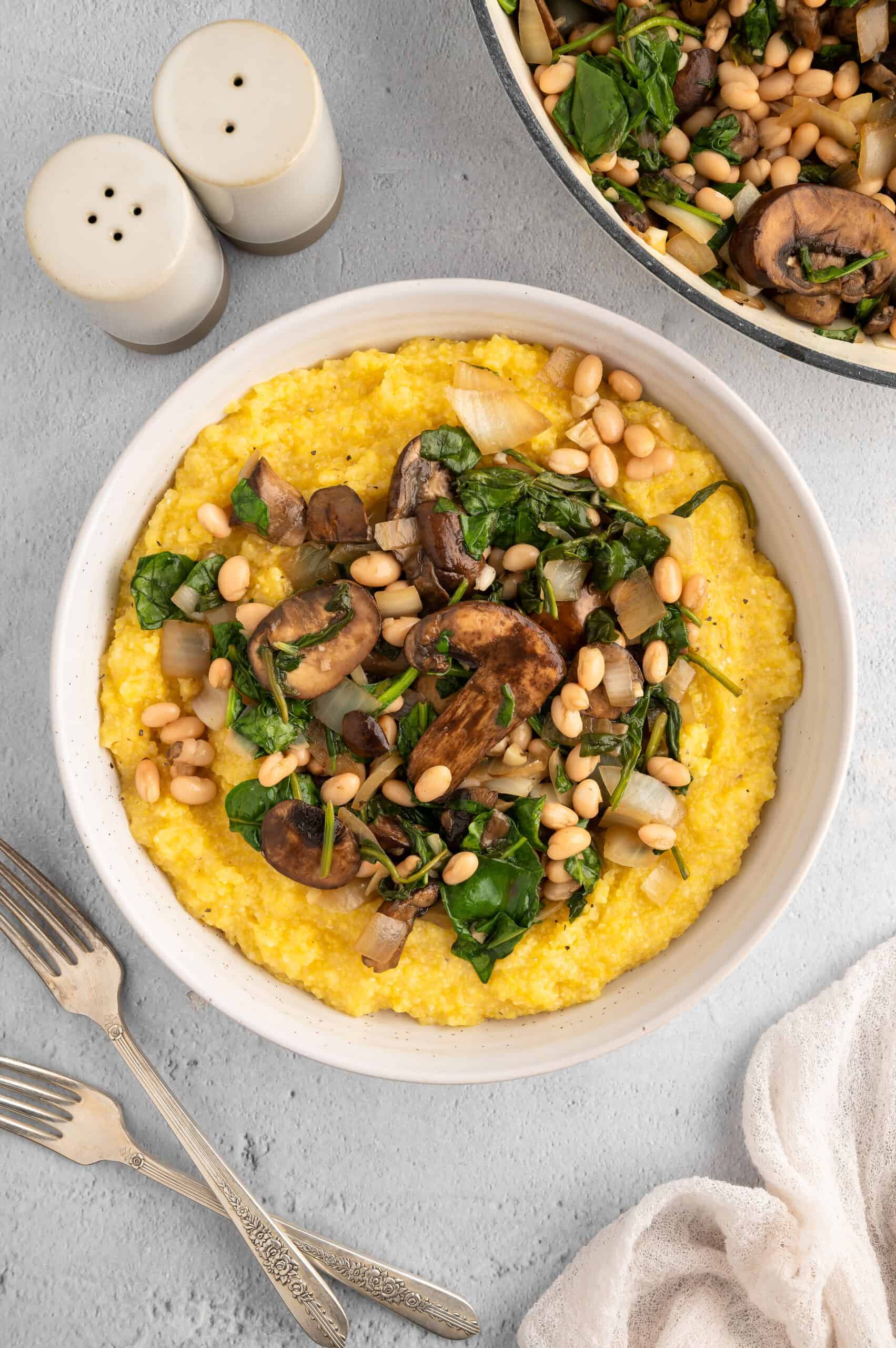 Vegan polenta and greens, served in a bowl.