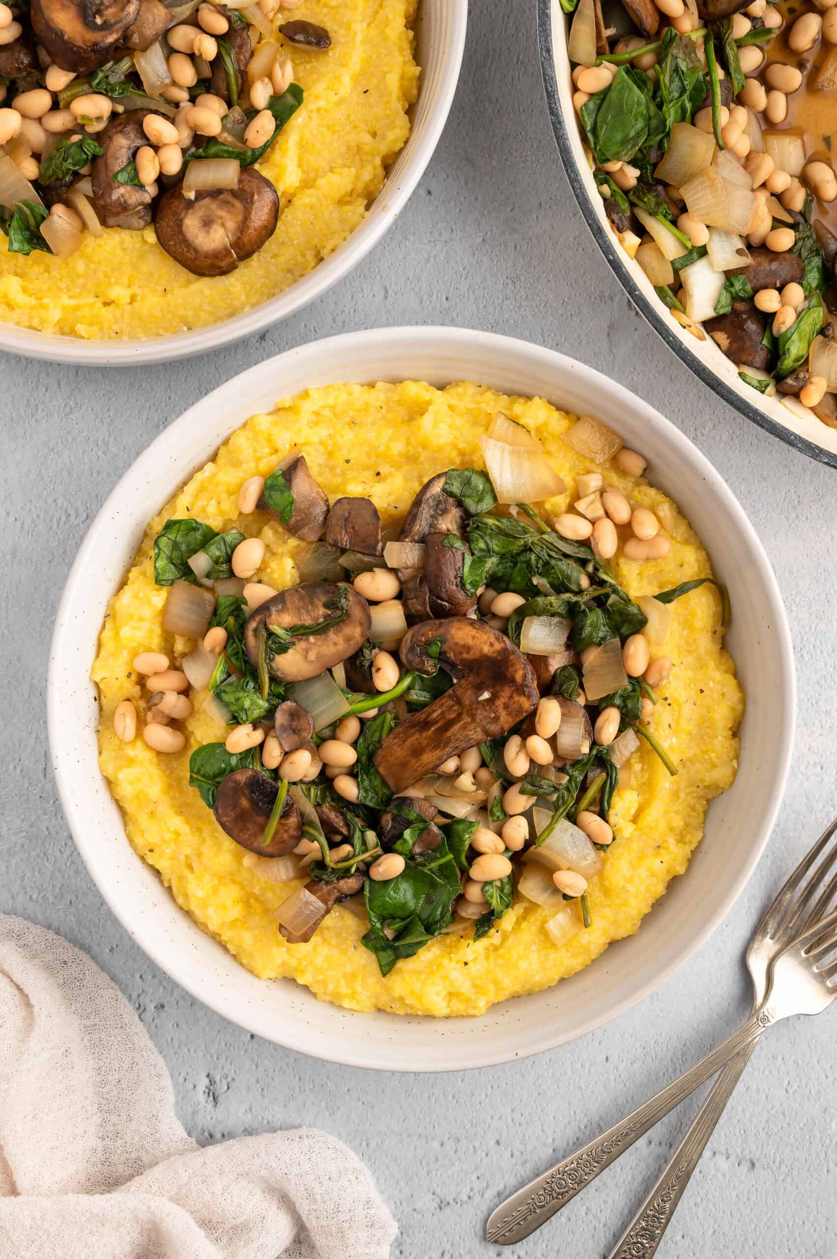 Two bowls of vegan polenta and greens.