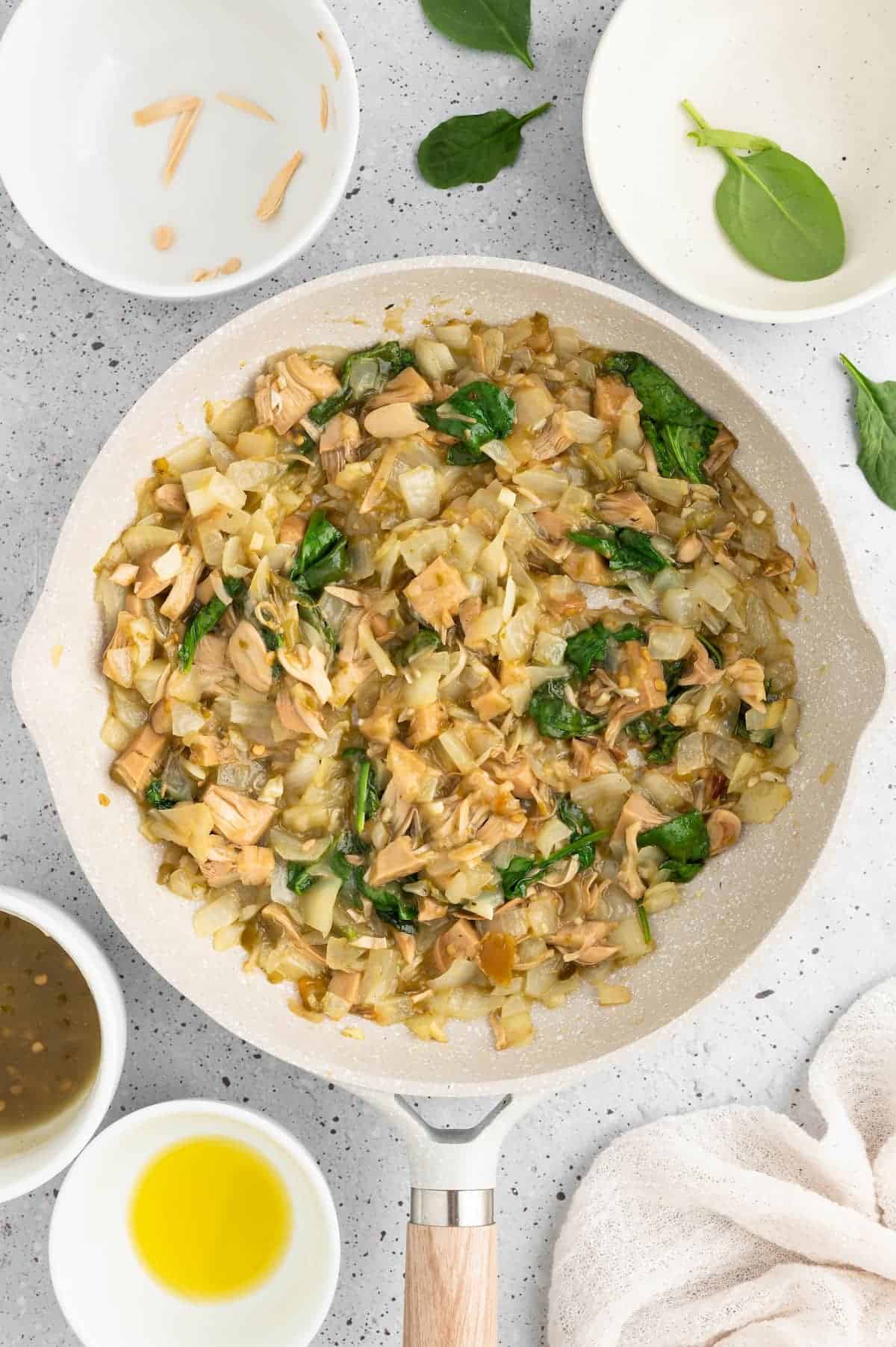 Vegan tamale filling simmering in a pan.