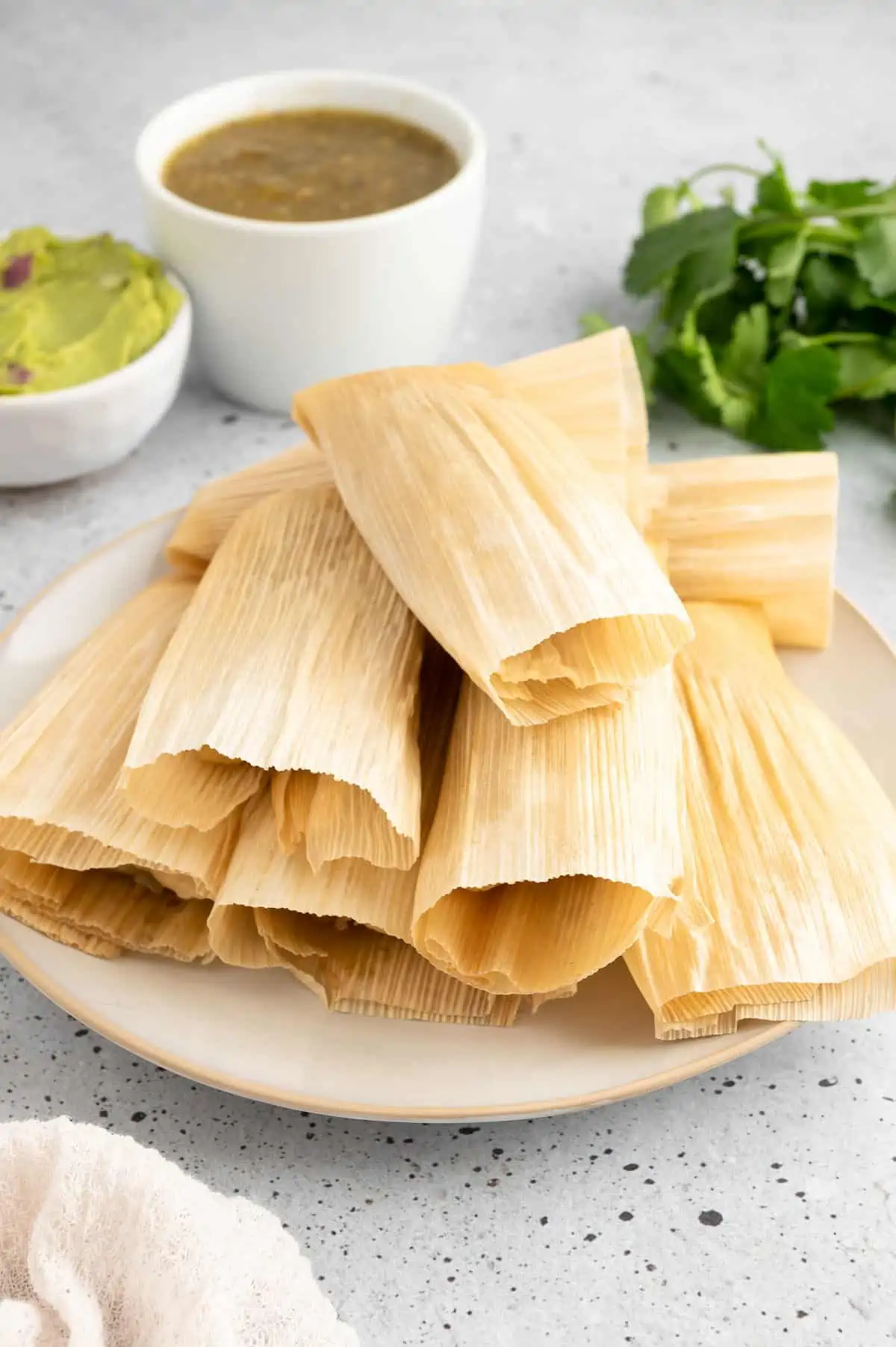 Vegan tamales stacked on a serving platter.