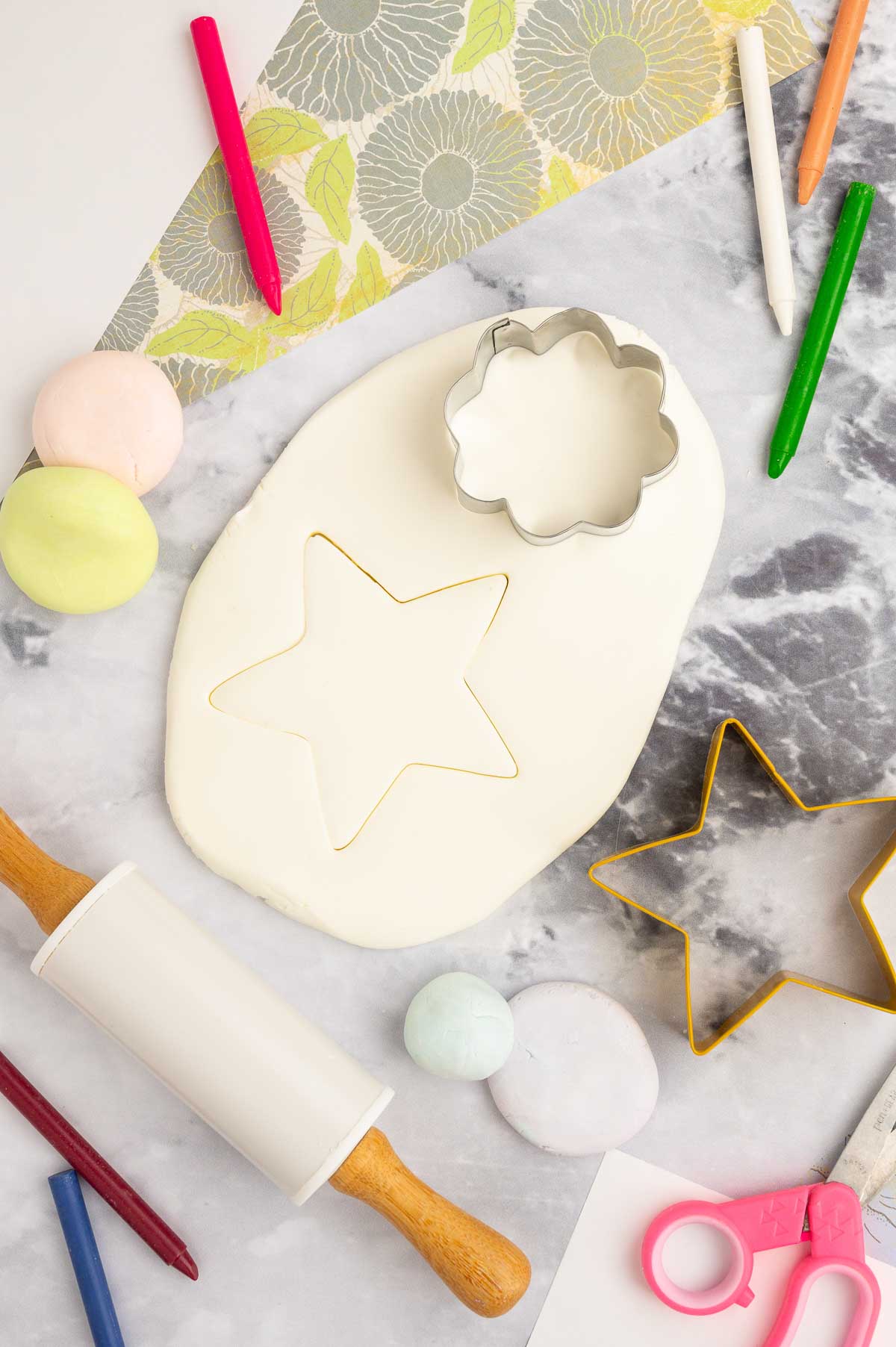 Cloud dough, rolled flat and cut with cookie cutter shapes.