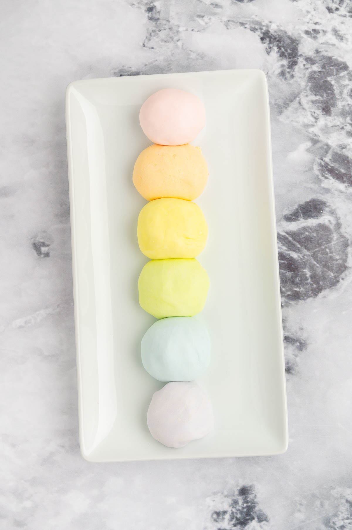 Cloud dough spheres, colored with food coloring.