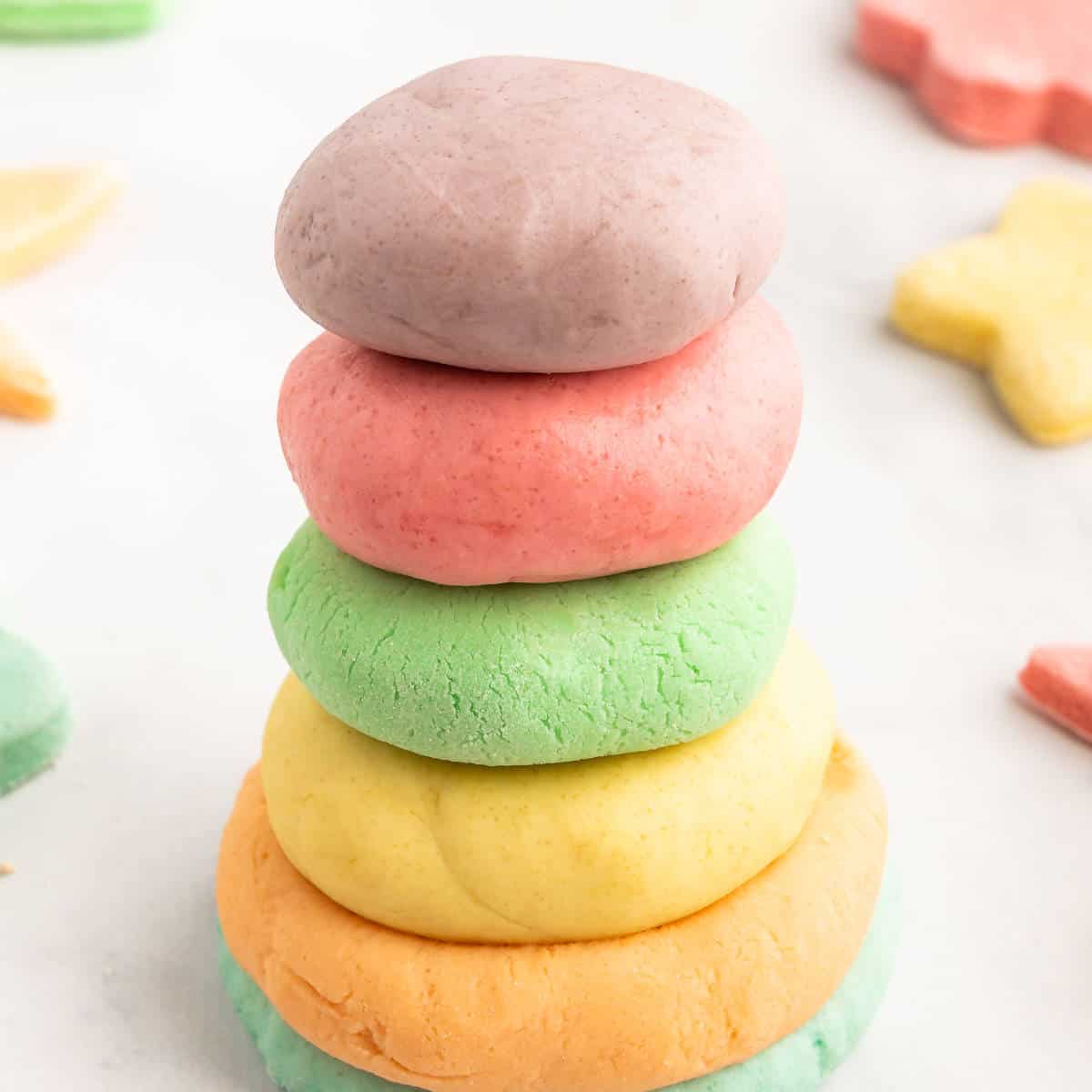 A stack of colorful balls of homemade play dough.