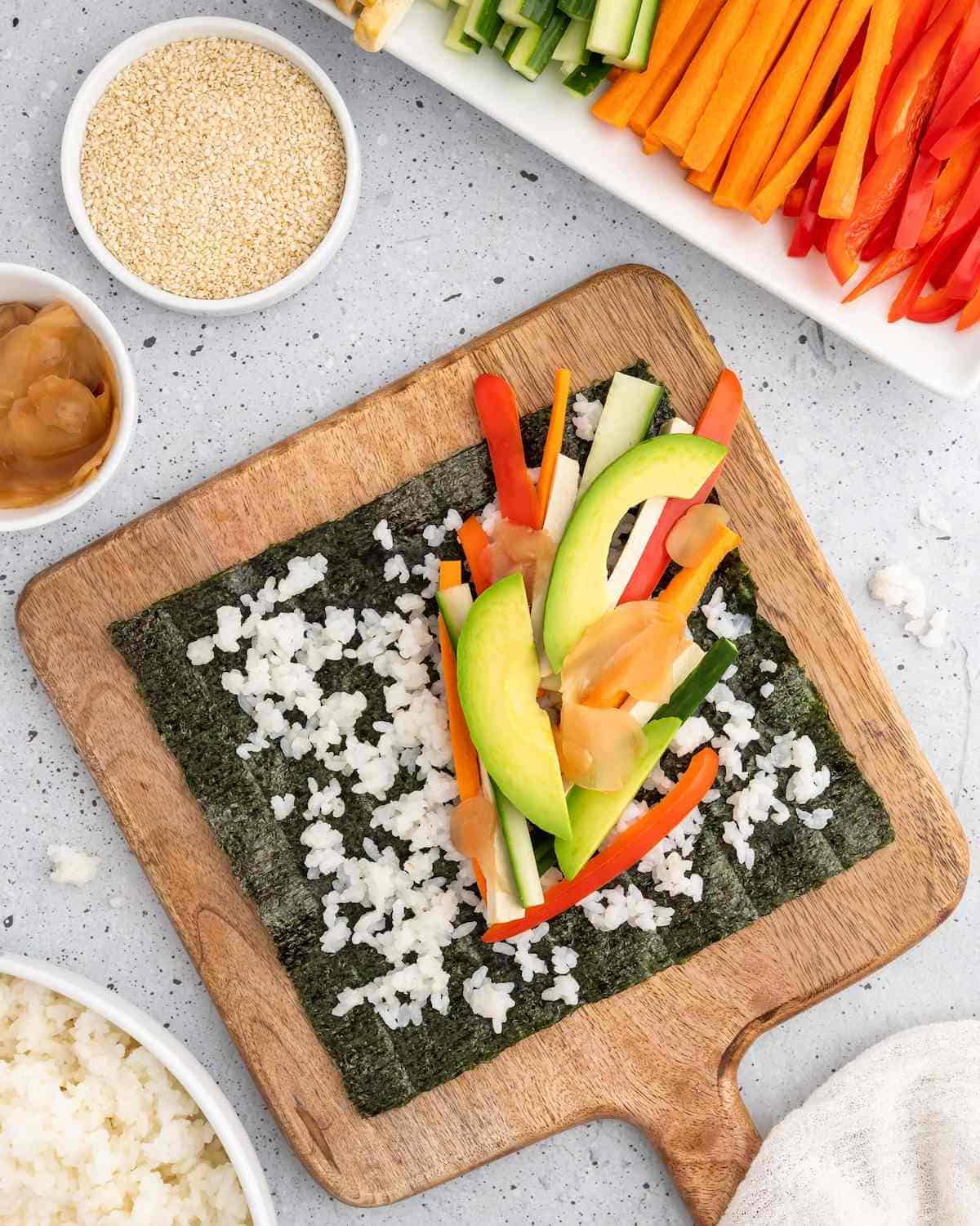 Vegetables, tofu, and rice, placed on a nori sheet.