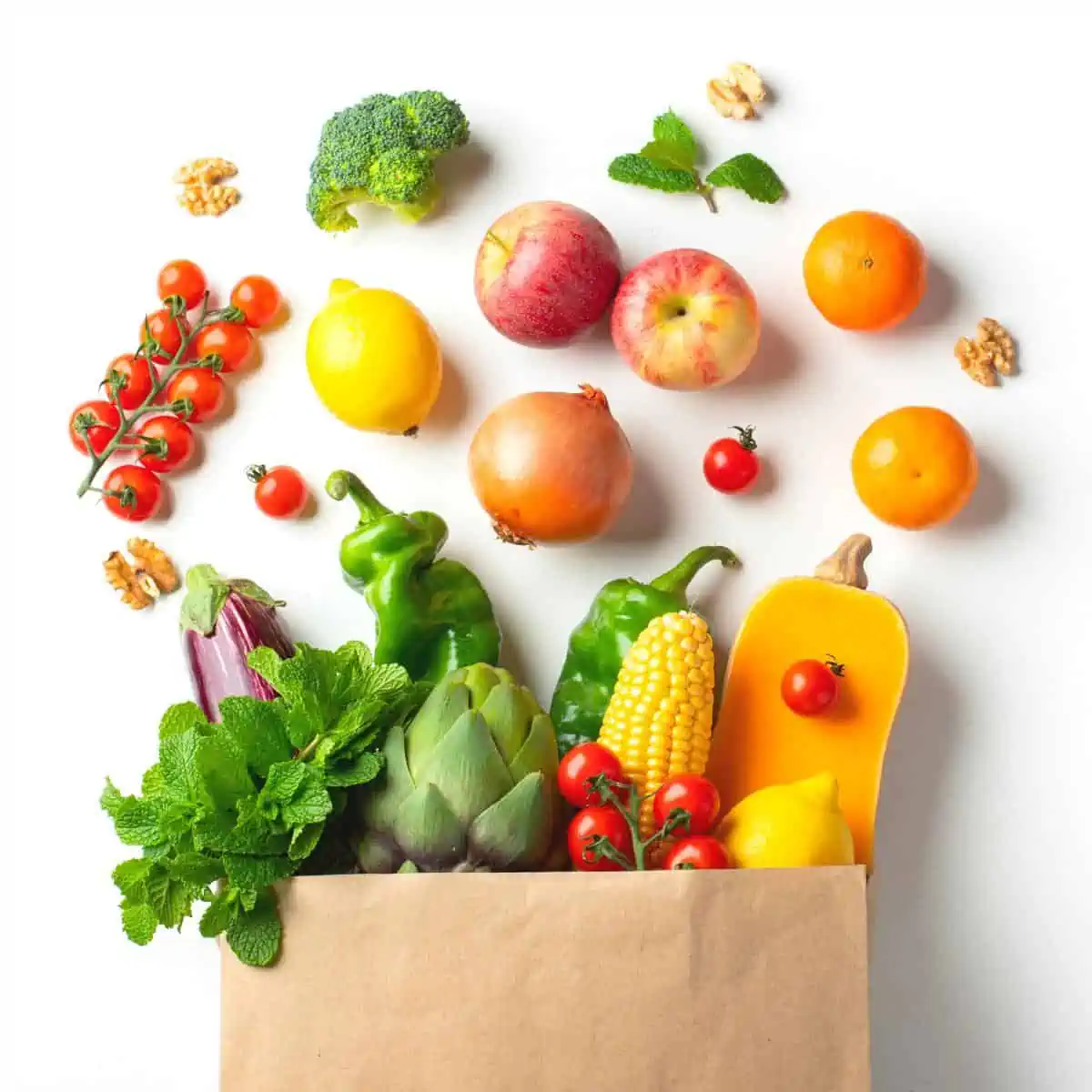 Grocery bag with going vegan essentials like fruit and veggies.