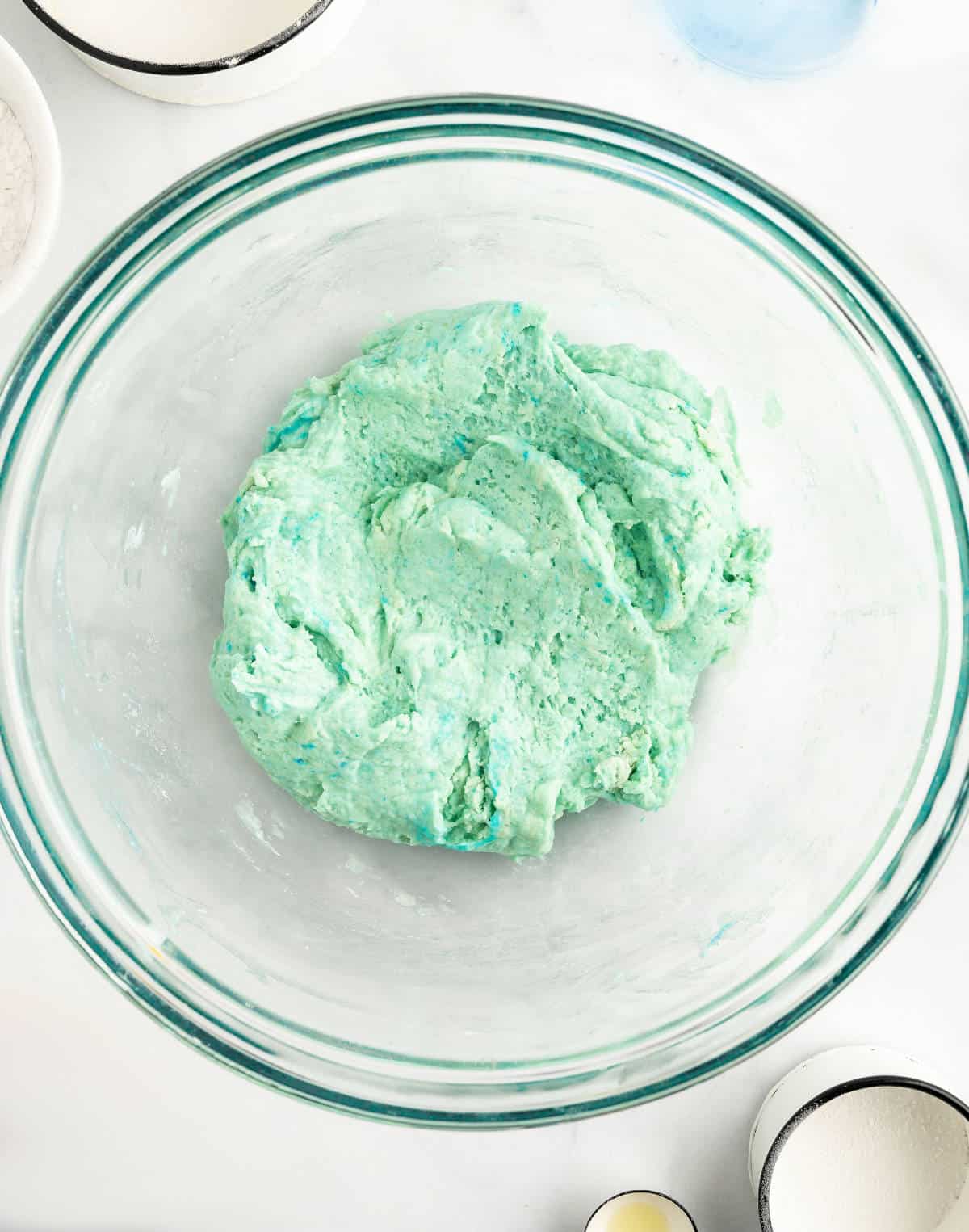 Water and food coloring added to the bowl and mixed to create a green dough.