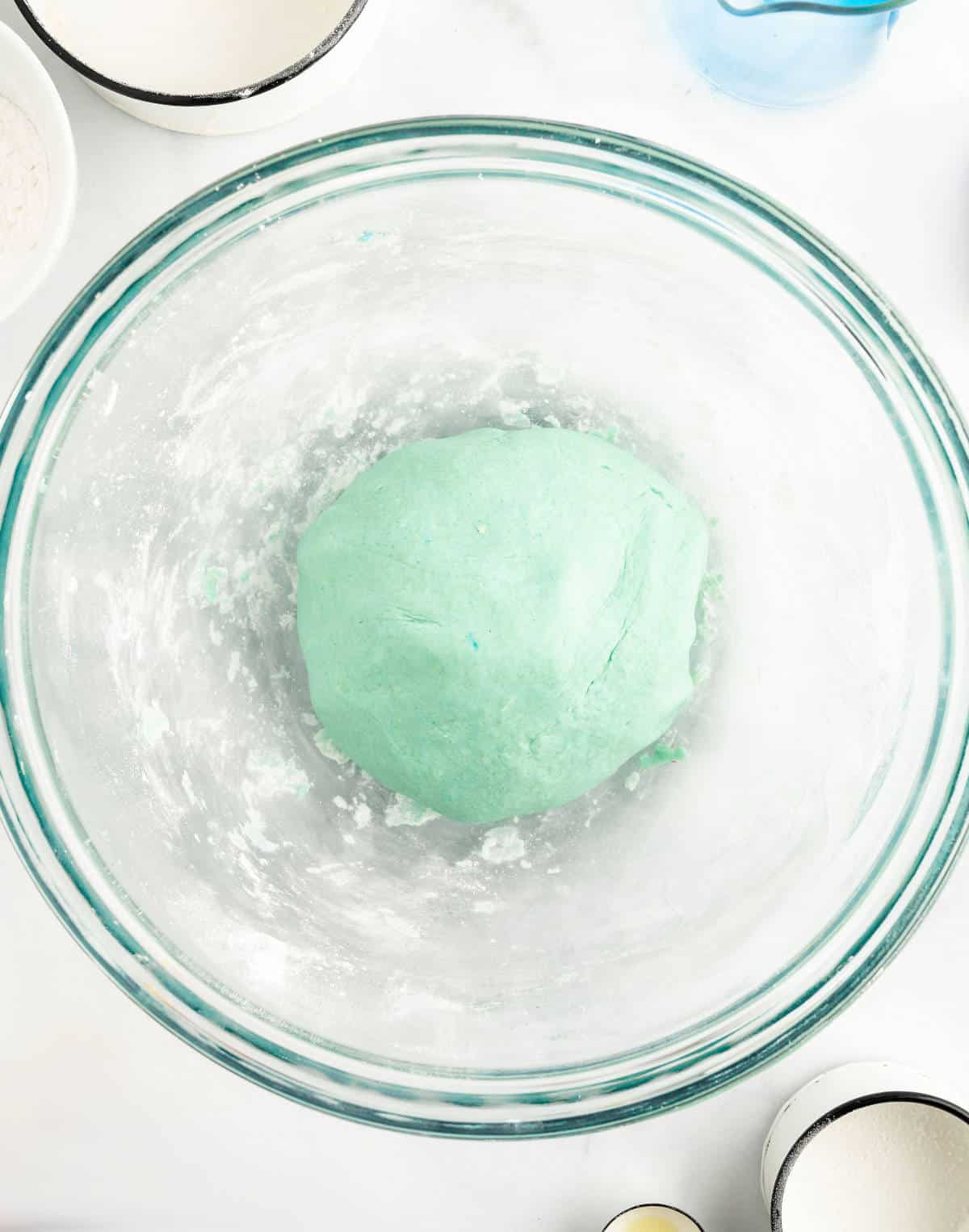 Playdough recipe in mixing bowl after it's been fully mixed into  a smooth ball.