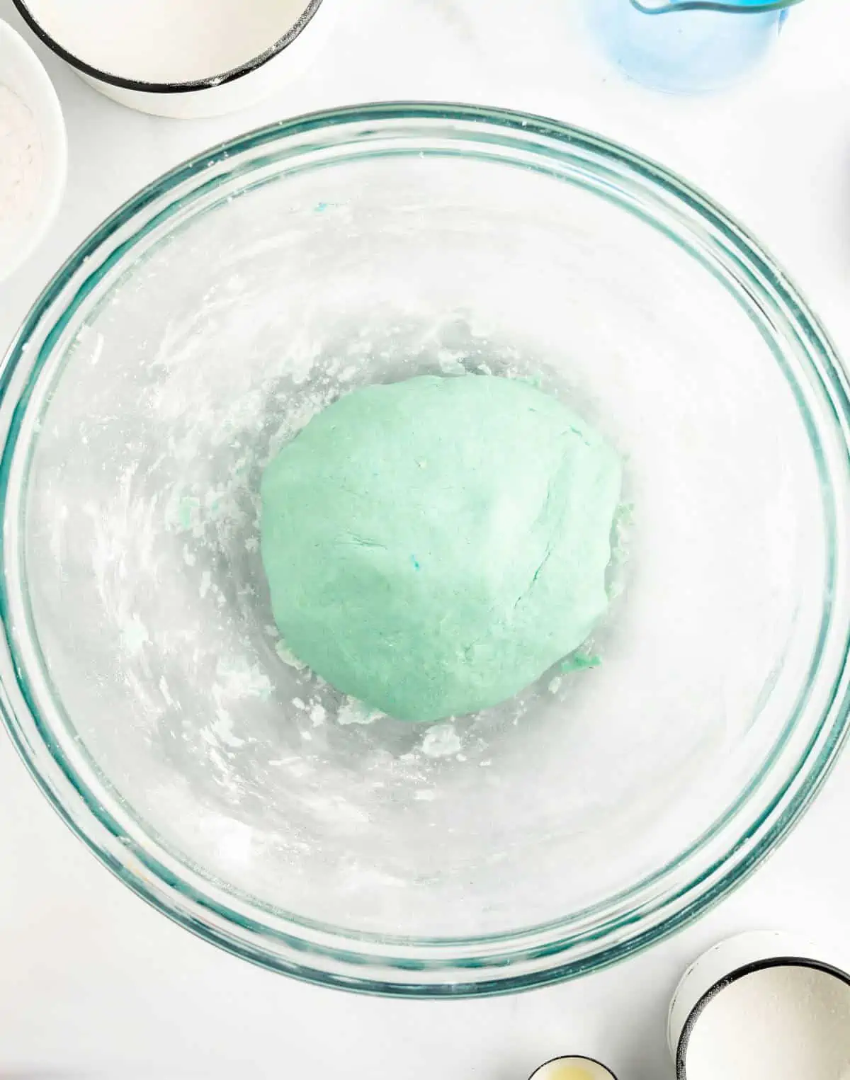 Playdough recipe in mixing bowl after it's been fully mixed into  a smooth ball.