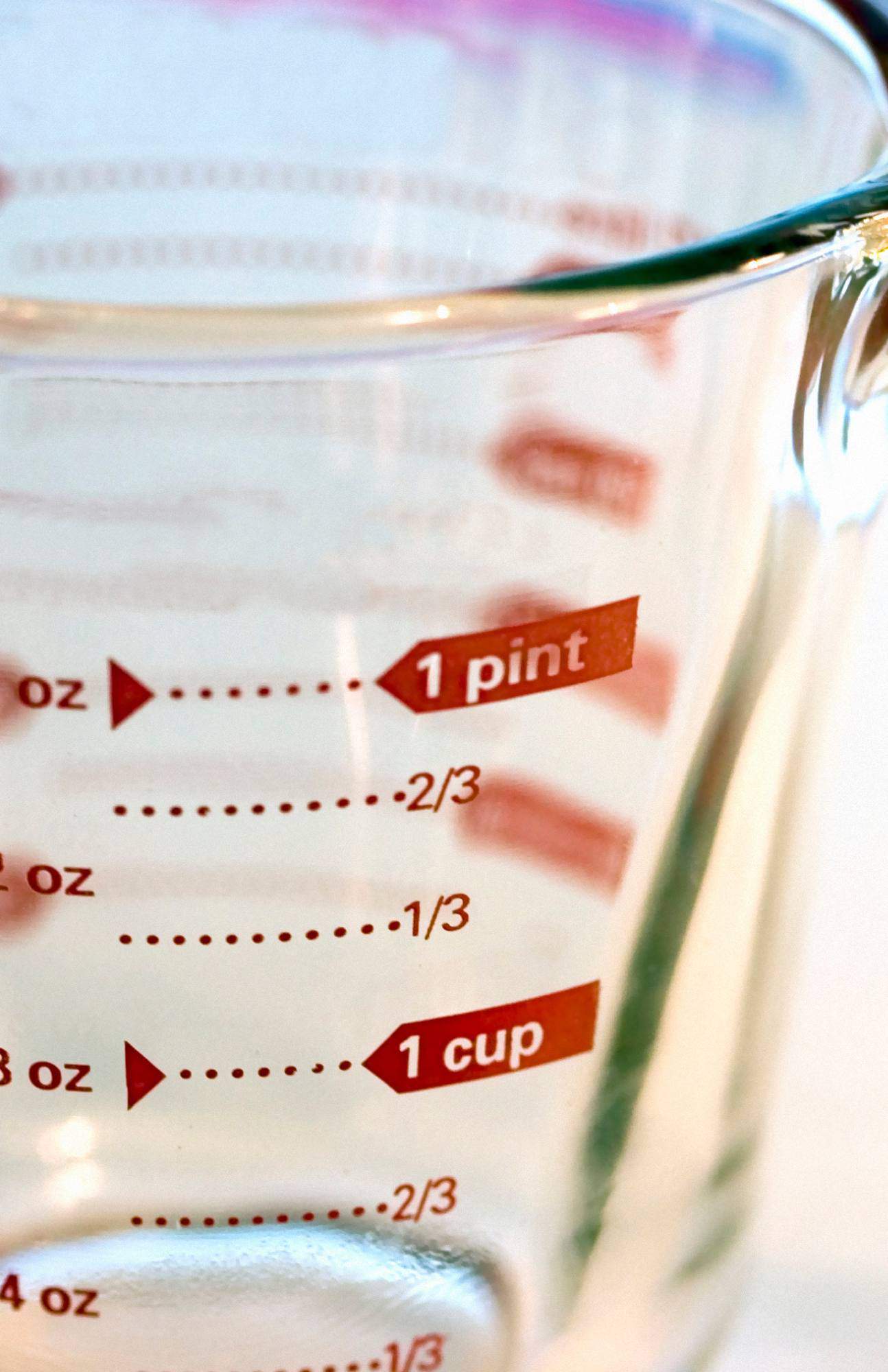 Pyrex liquid measuring cup showing number of ounces in a pint and cup. 