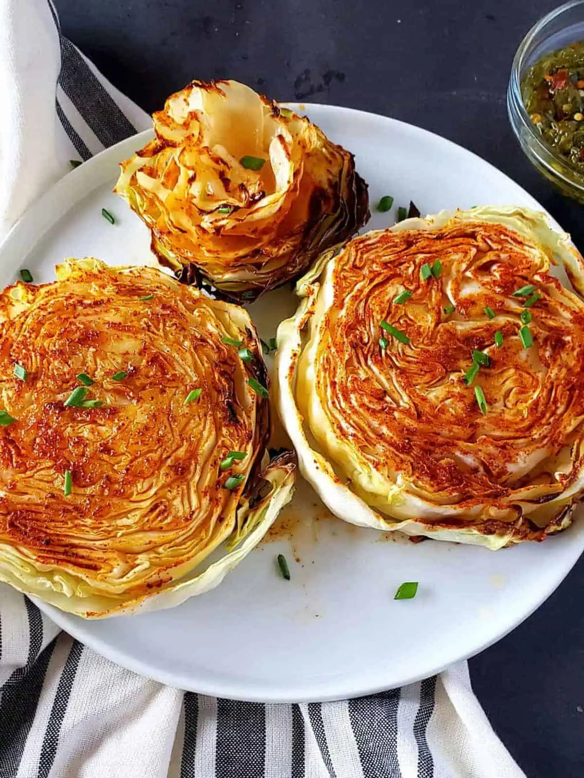 Cabbage steaks on a plate.