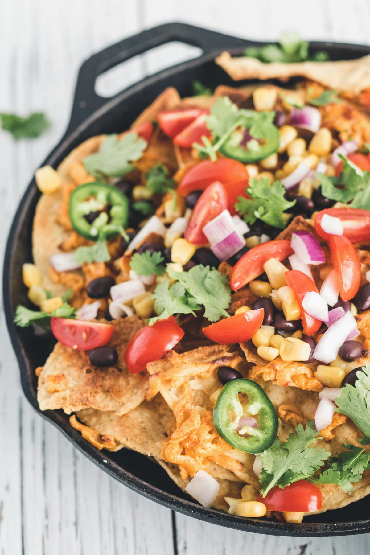 A skillet with fully loaded vegan nachos.