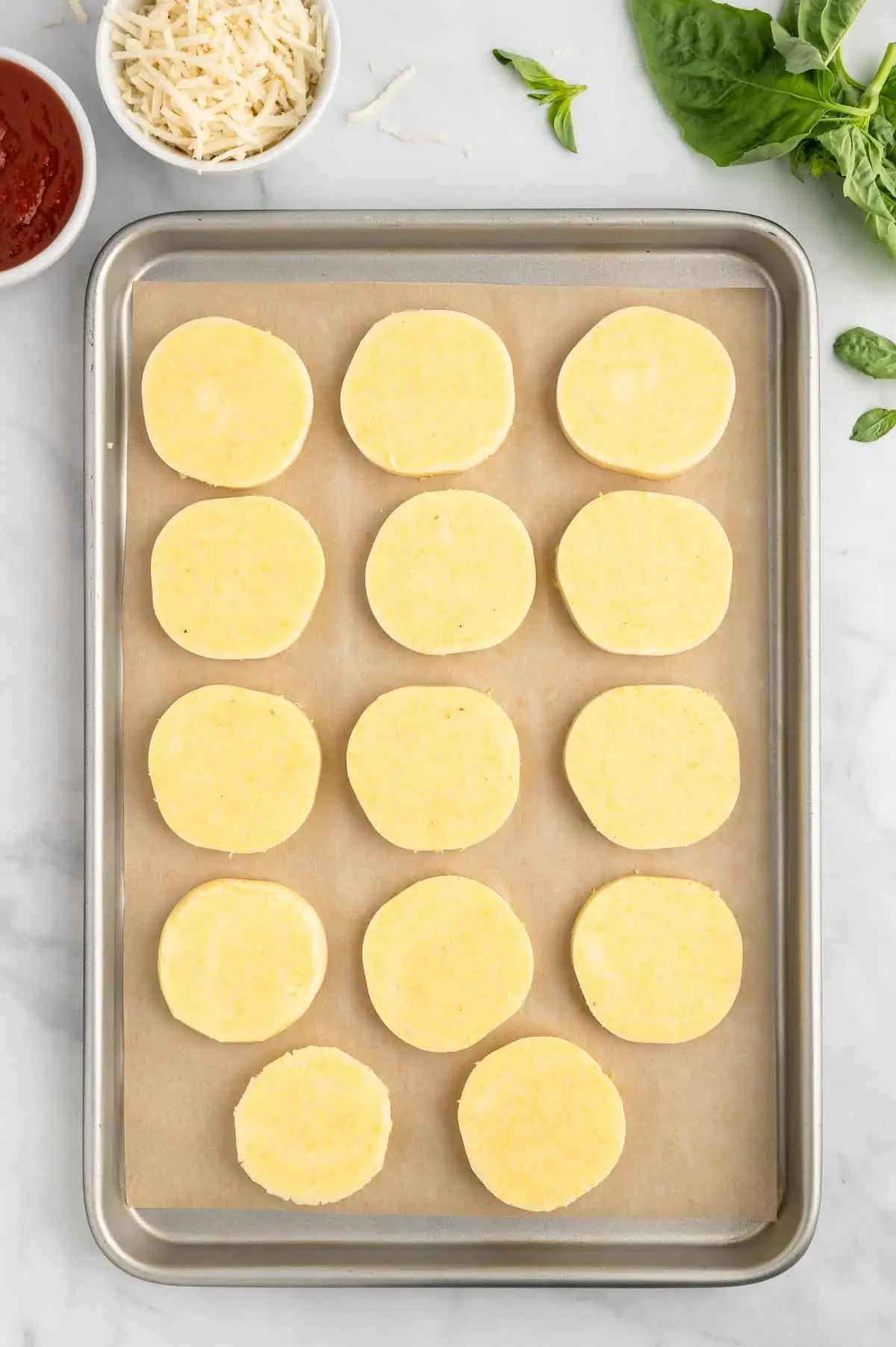 Sliced polenta on a baking sheet.