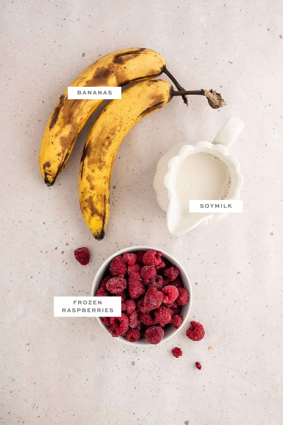 Ingredients for a raspberry smoothie with labels.